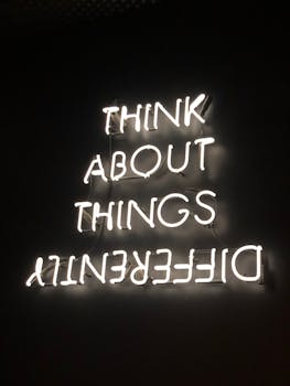 pexels photo 2681319 2681319 A glowing neon sign displaying an upside-down motivational quote against a dark background.